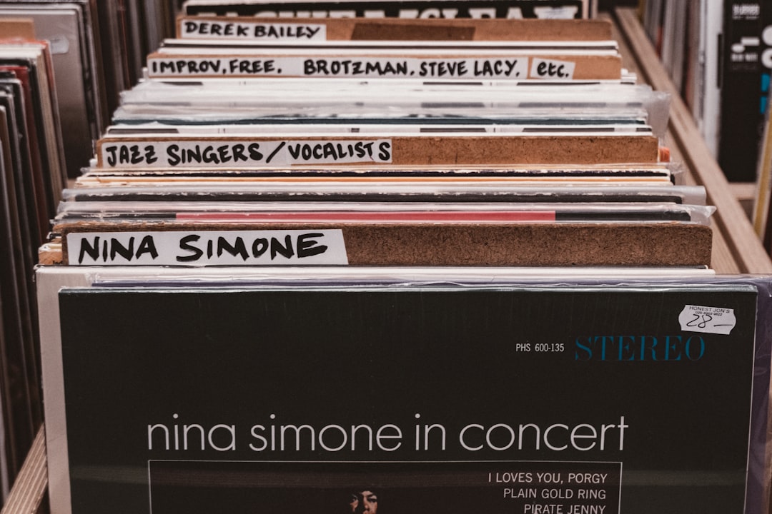 Stack of vinyl jazz records on a wooden shelf
