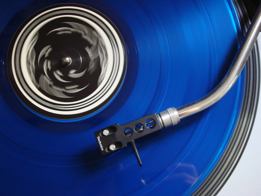Close-up of a turntable tonearm with cartridge mounted, showing alignment setup
