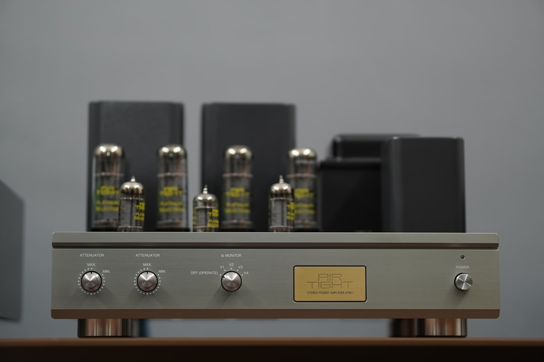 Vintage tube amplifier with glowing vacuum tubes and silver control panel
